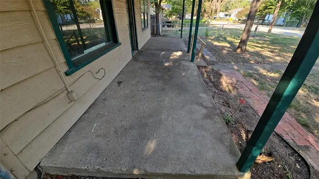 a view of a pathway of a house with backyard and garden