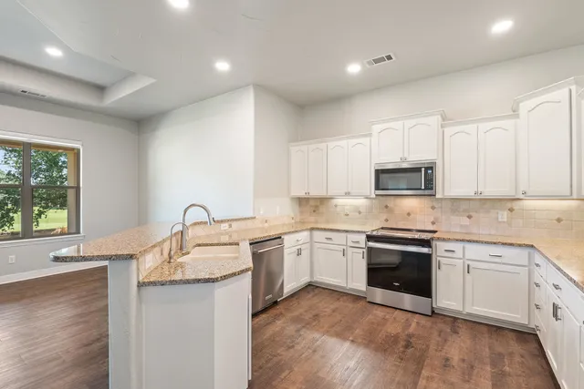 a kitchen with a sink cabinets and window
