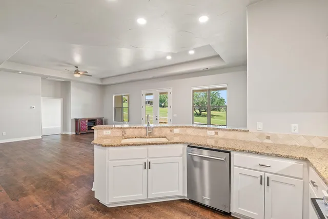 an empty room with wooden floor and a window