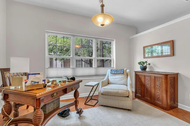 a dining room with furniture a chandelier and wooden floor