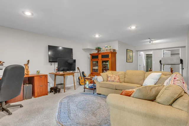 a living room with furniture a rug and a table