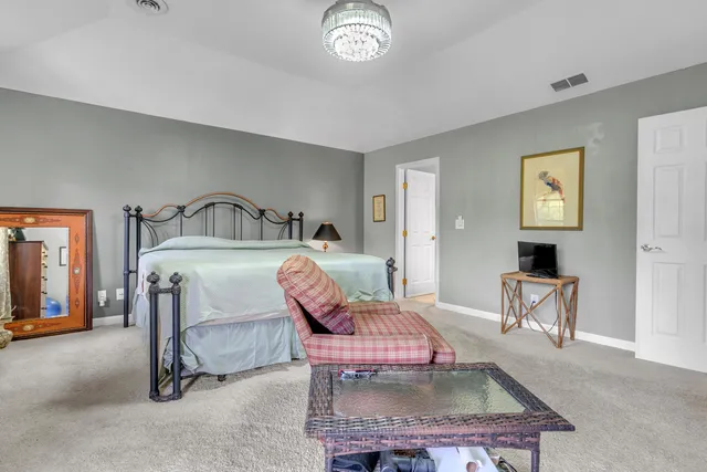 a bedroom with furniture and a chandelier