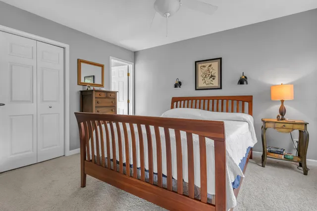 a bedroom with a large bed and a chandelier