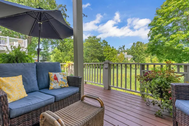a view of a balcony with wooden floor and fence