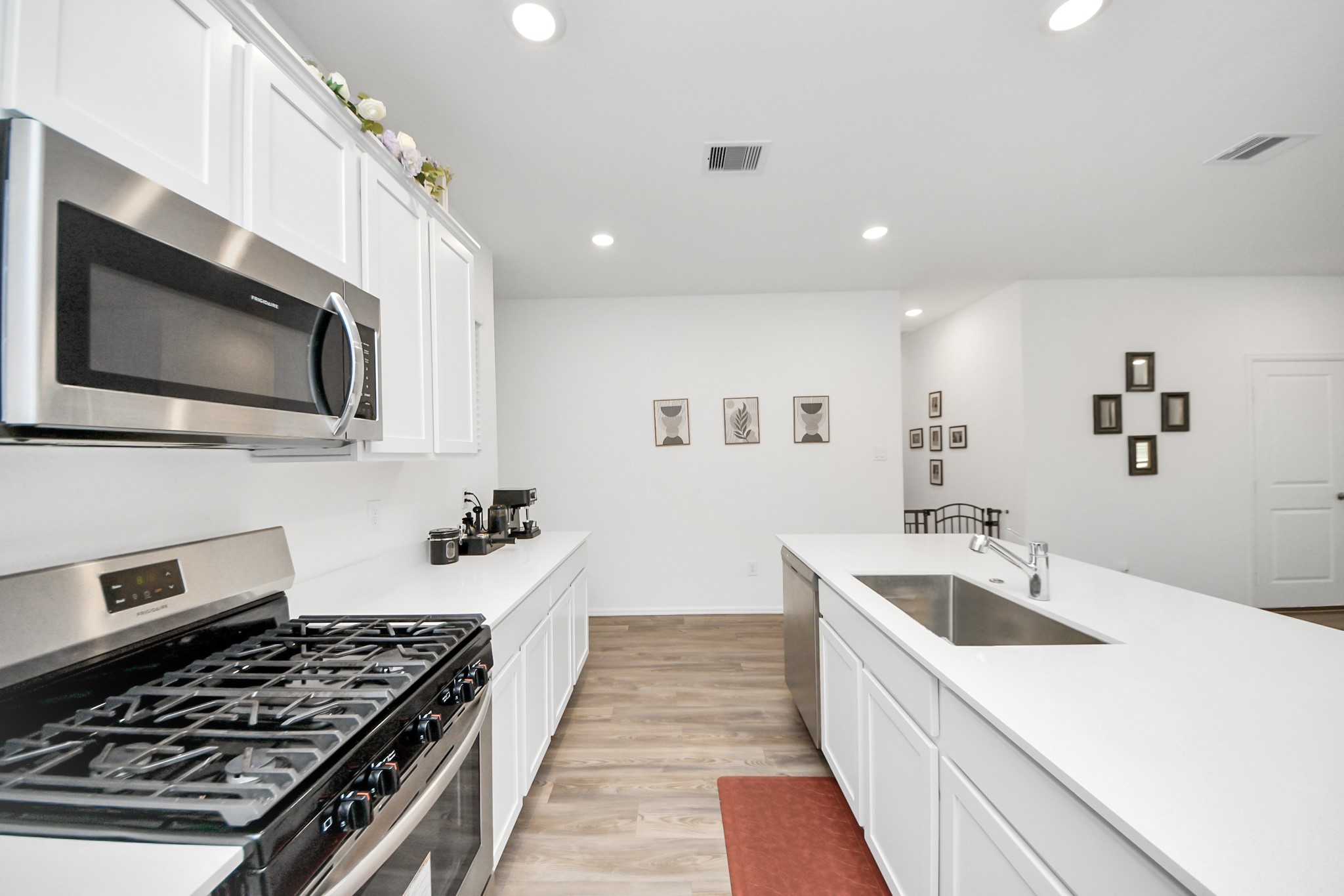 5418 Rabbit Crk Lane Richmond, TX 77469 - Photo 13 of 36 a kitchen with a sink a stove and microwave