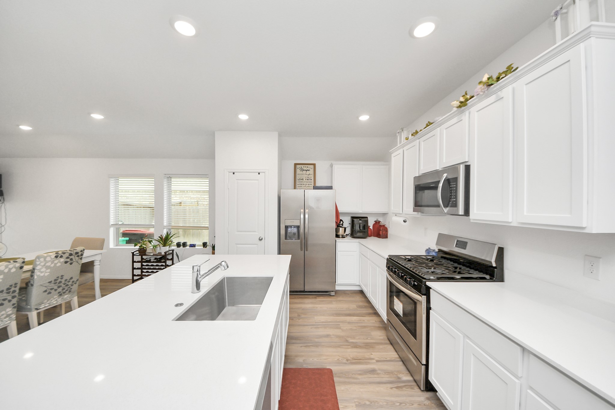 5418 Rabbit Crk Lane Richmond, TX 77469 - Photo 14 of 36 a large white kitchen with stainless steel appliances