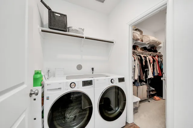 a view of walk in closet with clothes and shoes