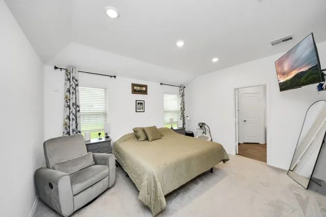 a bedroom with a bed and a couch