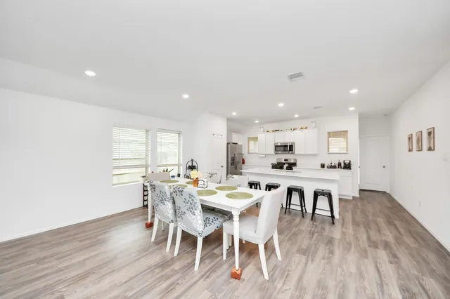 a view of a dining room with furniture and wooden floor