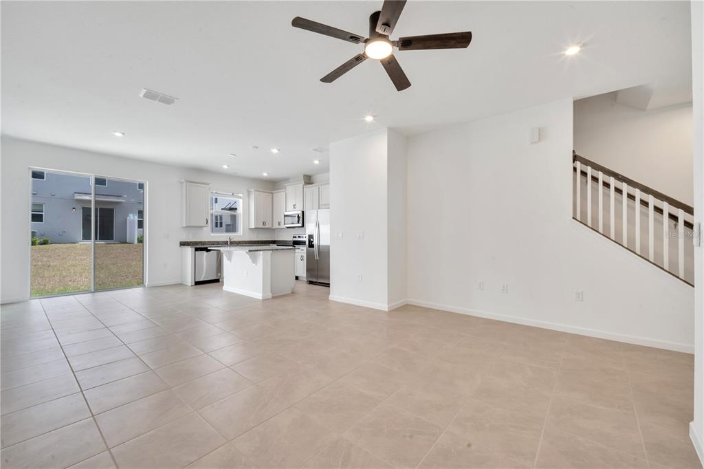 9068 Ocean Tide Way Kissimmee, FL 34747 - Photo 15 of 42 a view of a kitchen with a sink and cabinets