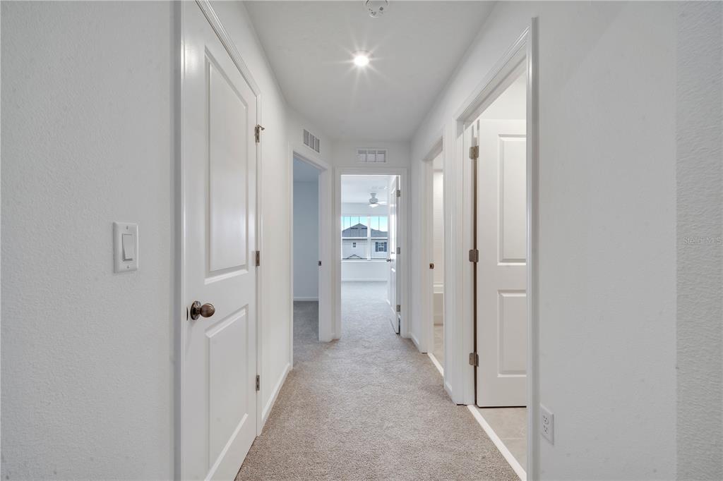 9068 Ocean Tide Way Kissimmee, FL 34747 - Photo 24 of 42 a view of a hallway with wooden shelves