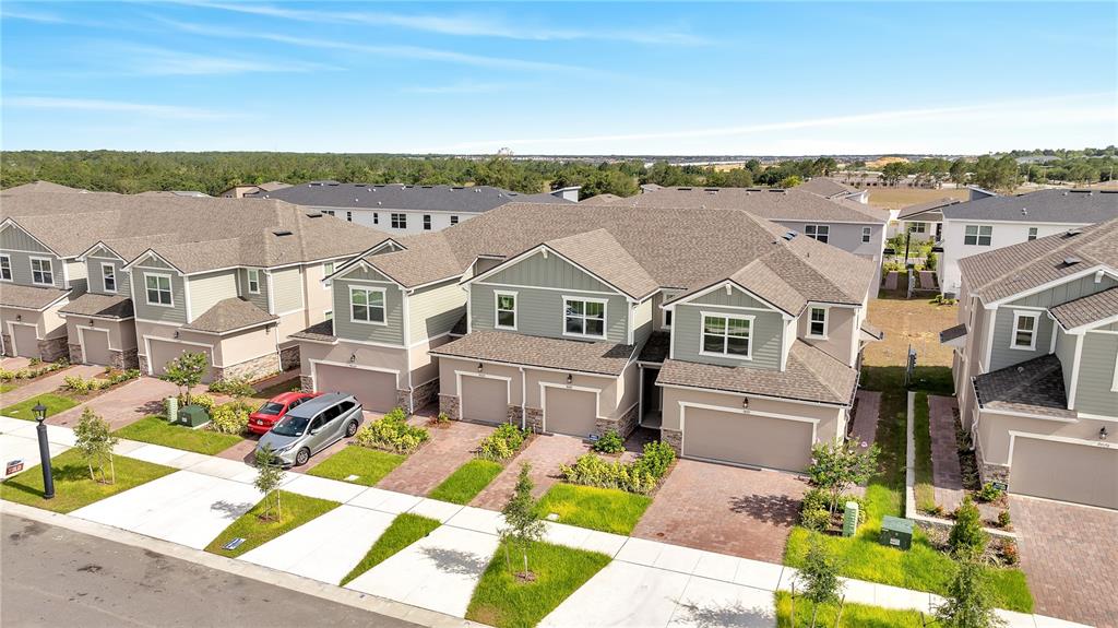 9068 Ocean Tide Way Kissimmee, FL 34747 - Photo 34 of 42 a aerial view of a house with a big yard plants and large tree