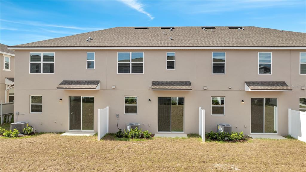 9068 Ocean Tide Way Kissimmee, FL 34747 - Photo 38 of 42 a front view of a house with a yard