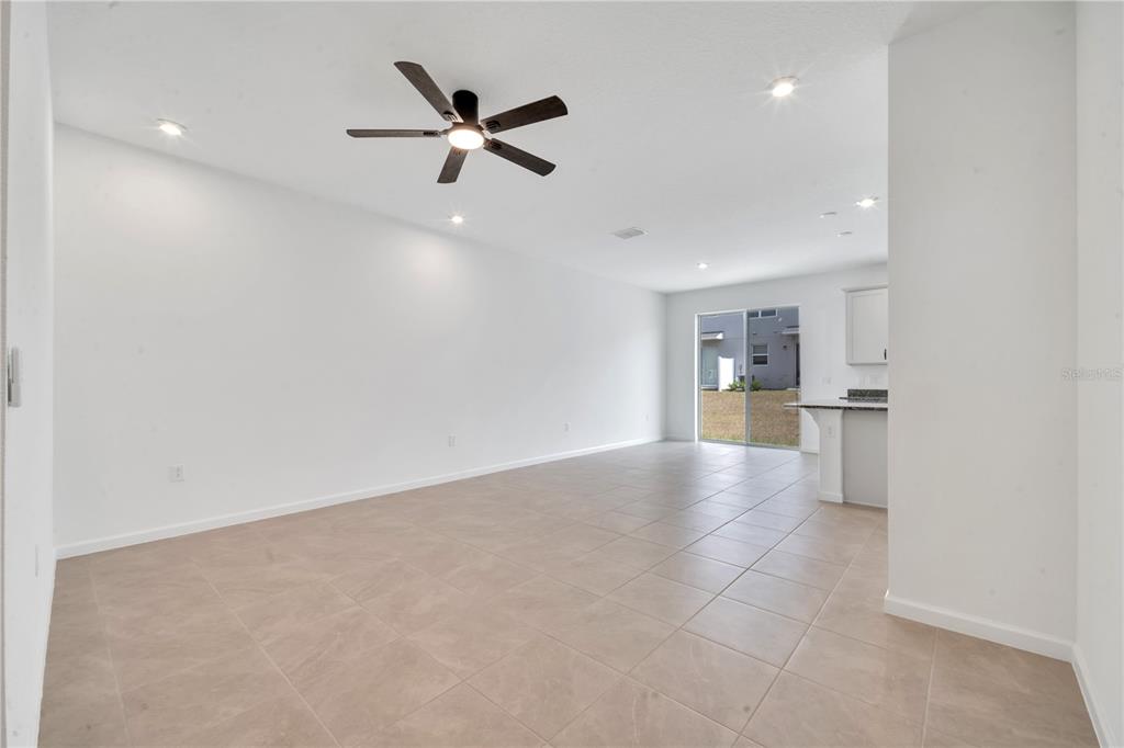 9068 Ocean Tide Way Kissimmee, FL 34747 - Photo 7 of 42 a view of a kitchen with a sink and stainless steel appliances