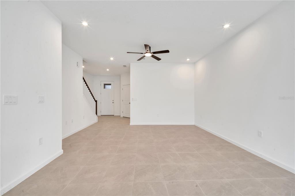 9068 Ocean Tide Way Kissimmee, FL 34747 - Photo 8 of 42 an empty room with a ceiling fan and a ceiling fan