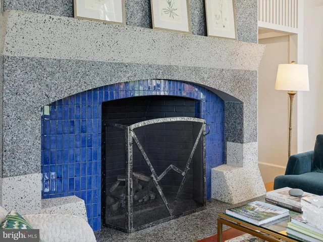 a kitchen with furniture and a fireplace
