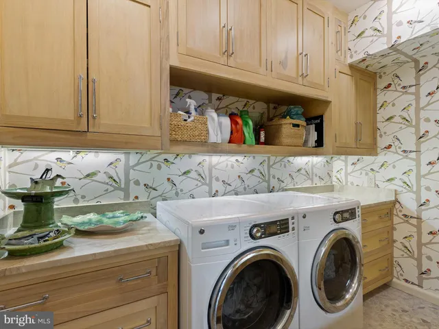 an aerial view of residential house with outdoor space and trees all around