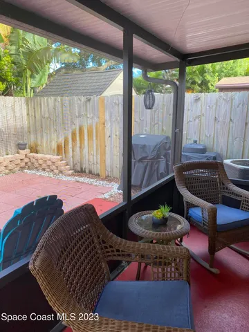 a view of a patio with table and chairs potted plants with wooden floor