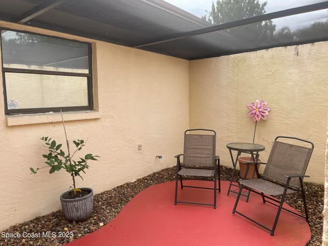 a dining room with furniture and a potted plant