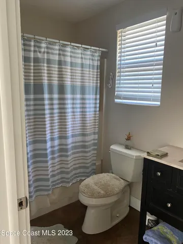 a bathroom with a toilet a sink and a mirror