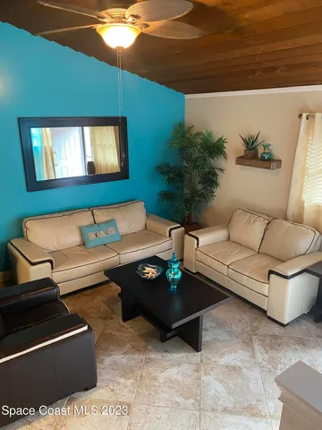 a living room with furniture and a potted plant