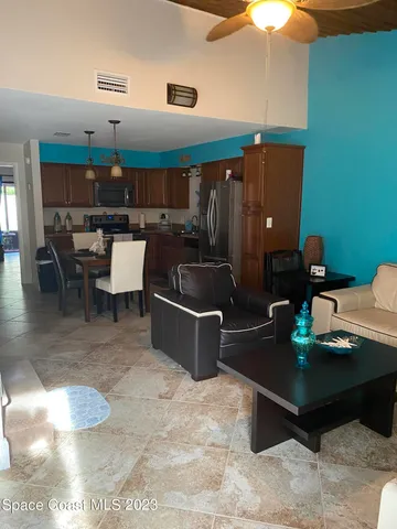 a living room with furniture and a lamp