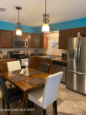 a kitchen with a dining table and chairs