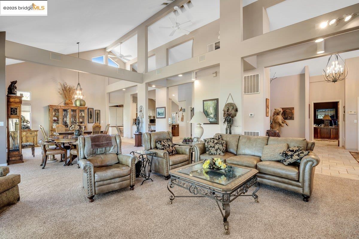 13700 Clements Road Groveland, CA 95321 - Photo 12 of 93 Living area featuring high vaulted ceiling, carpet floors, a chandelier, ceiling fan, and beamed ceiling