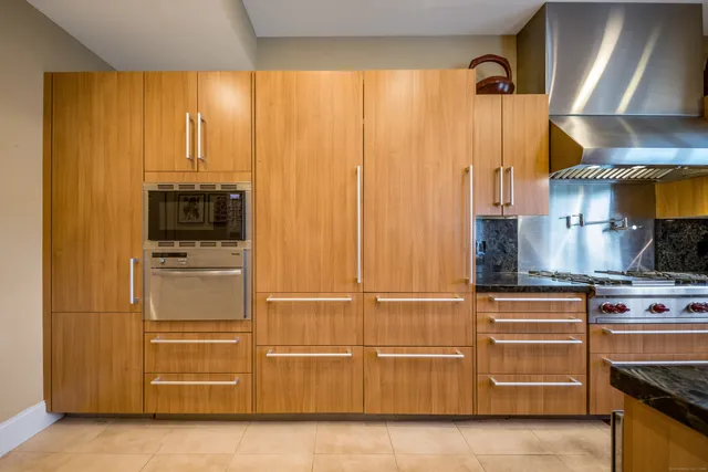 a kitchen with cabinets and stainless steel appliances
