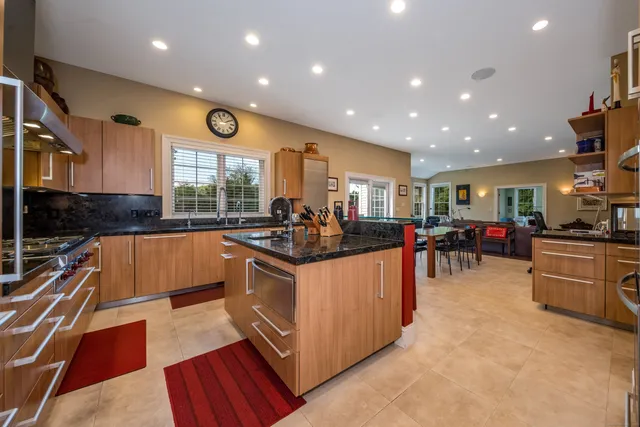 a kitchen with stainless steel appliances granite countertop a stove and a sink