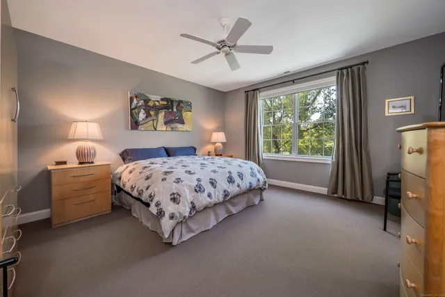 a bedroom with a bed dresser and a window