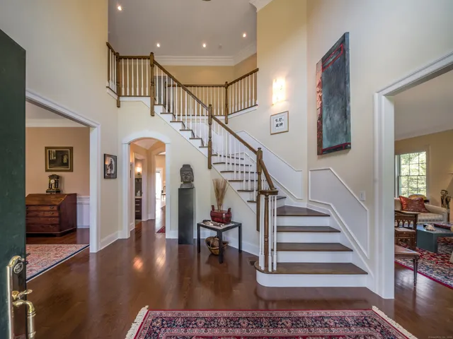 a view of entryway and hall with wooden floor
