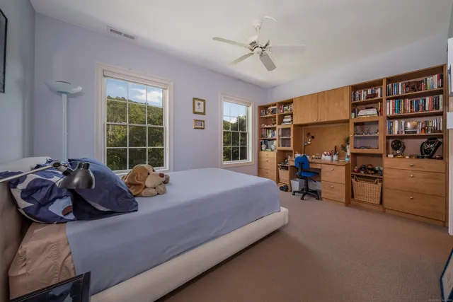 a bedroom with furniture and a large window