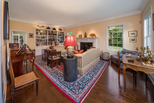 a living room with furniture flat screen tv and a large window