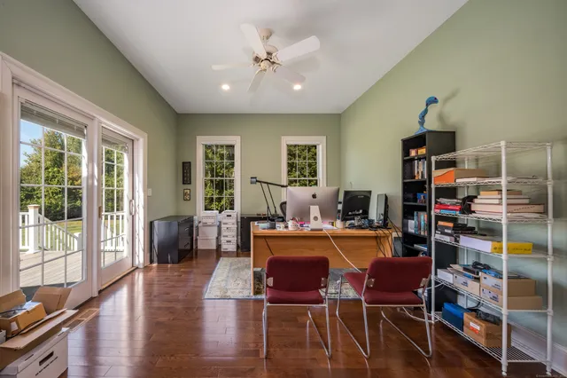 a dining room with wooden floor and furniture
