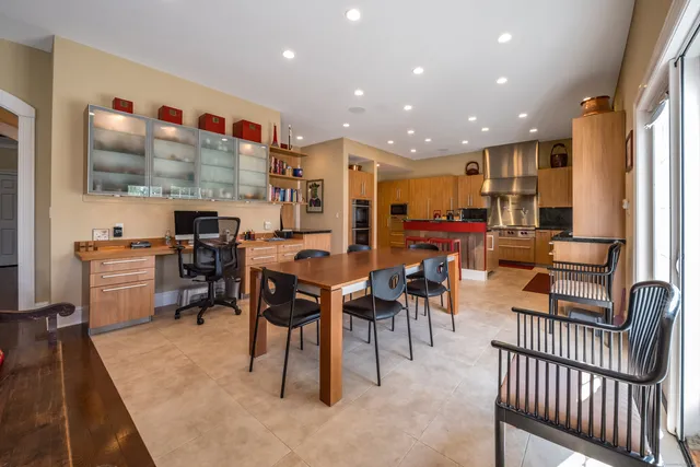 a living room with lots of furniture and kitchen view