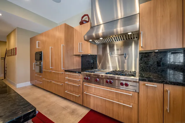 a kitchen with stainless steel appliances granite countertop a stove and a sink