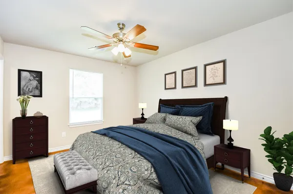 a bedroom with a bed and a chandelier