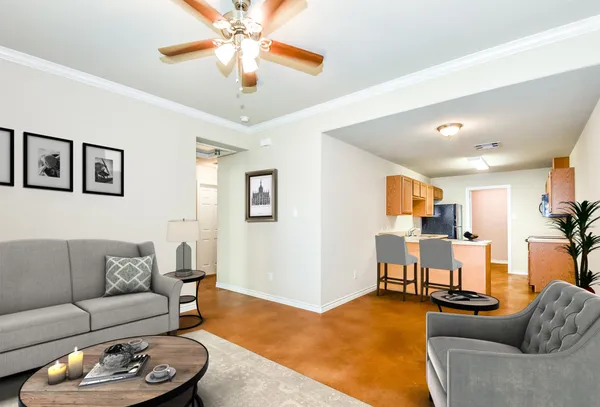 a living room with furniture and a chandelier