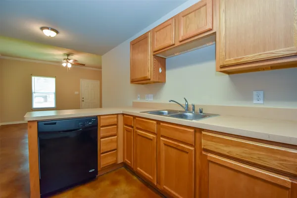 a kitchen with stainless steel appliances granite countertop a sink and cabinets