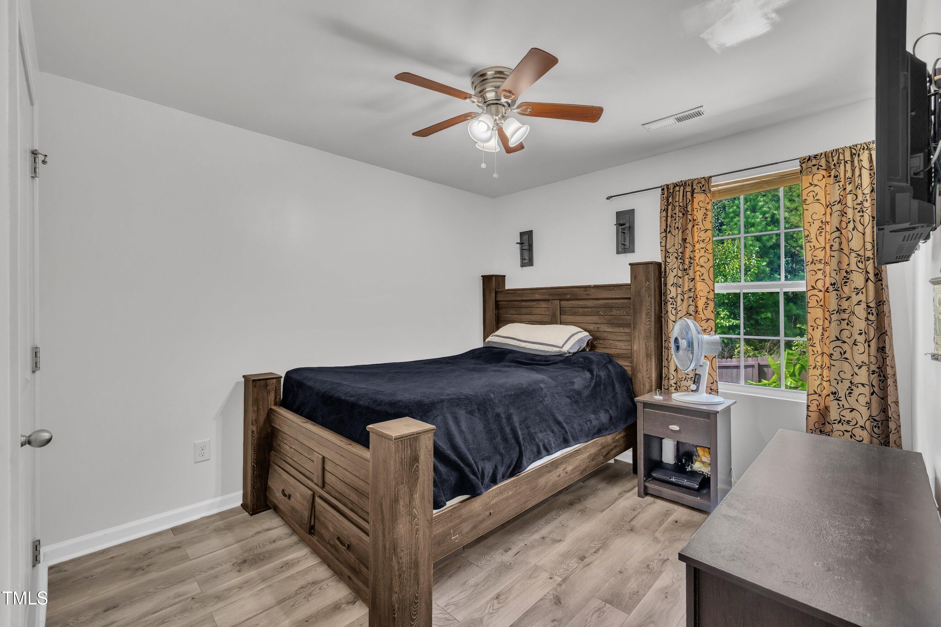 2816 Erinridge Road Raleigh, NC 27610 - Photo 10 of 20 a bed sitting in a spacious bedroom next to a window