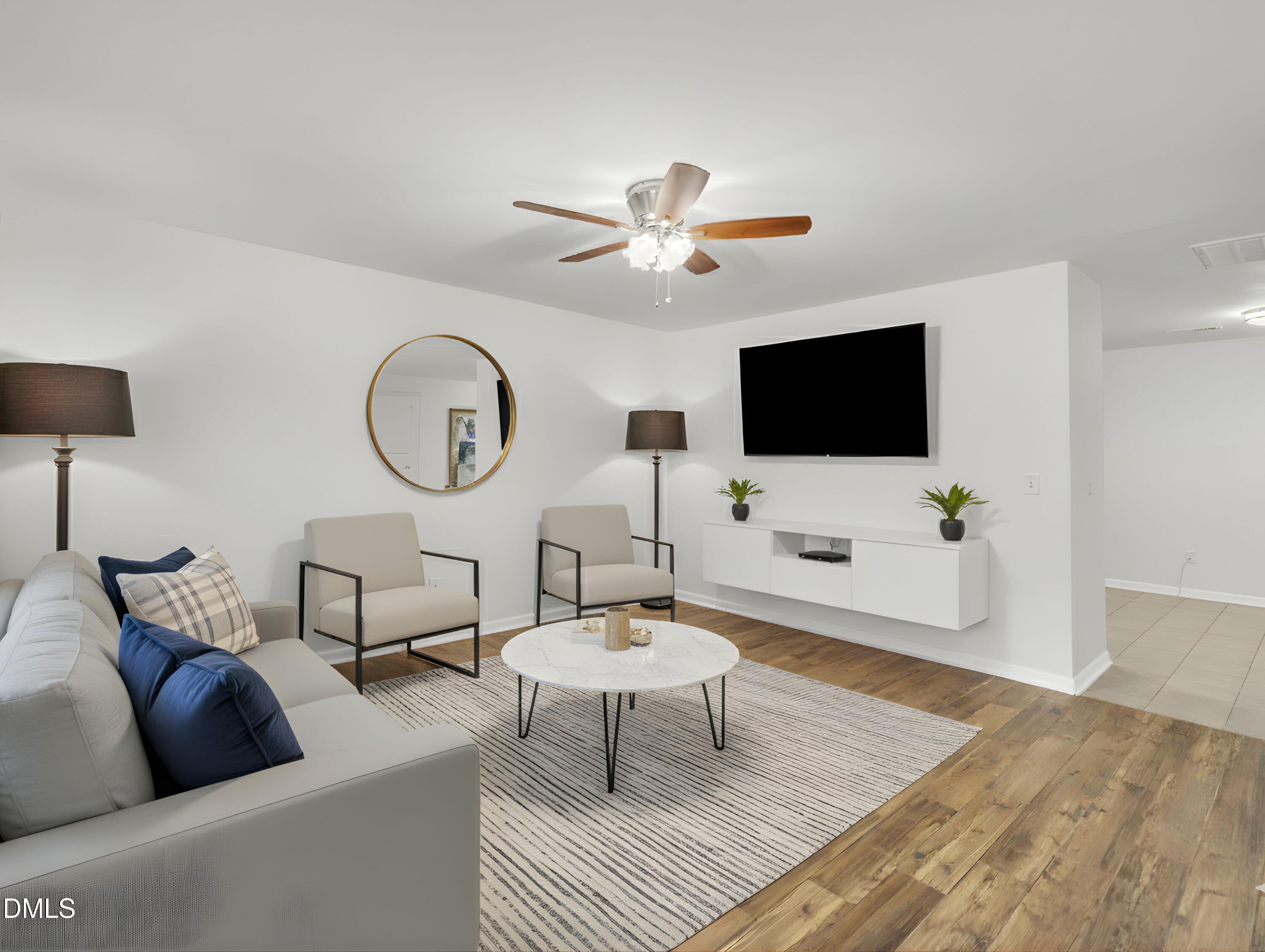 2816 Erinridge Road Raleigh, NC 27610 - Photo 3 of 20 a living room with furniture a flat screen tv and a window