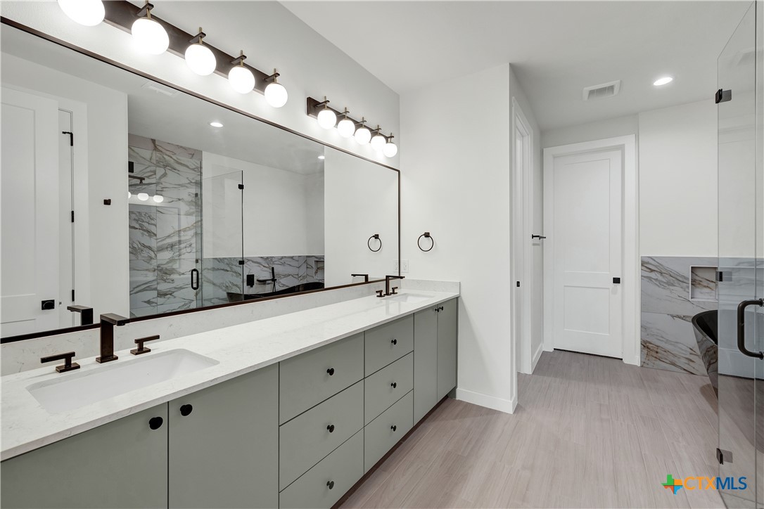328 Compass Rose Spring Branch, TX 78070 - Photo 27 of 48 a spacious bathroom with a double vanity sink mirror and double
