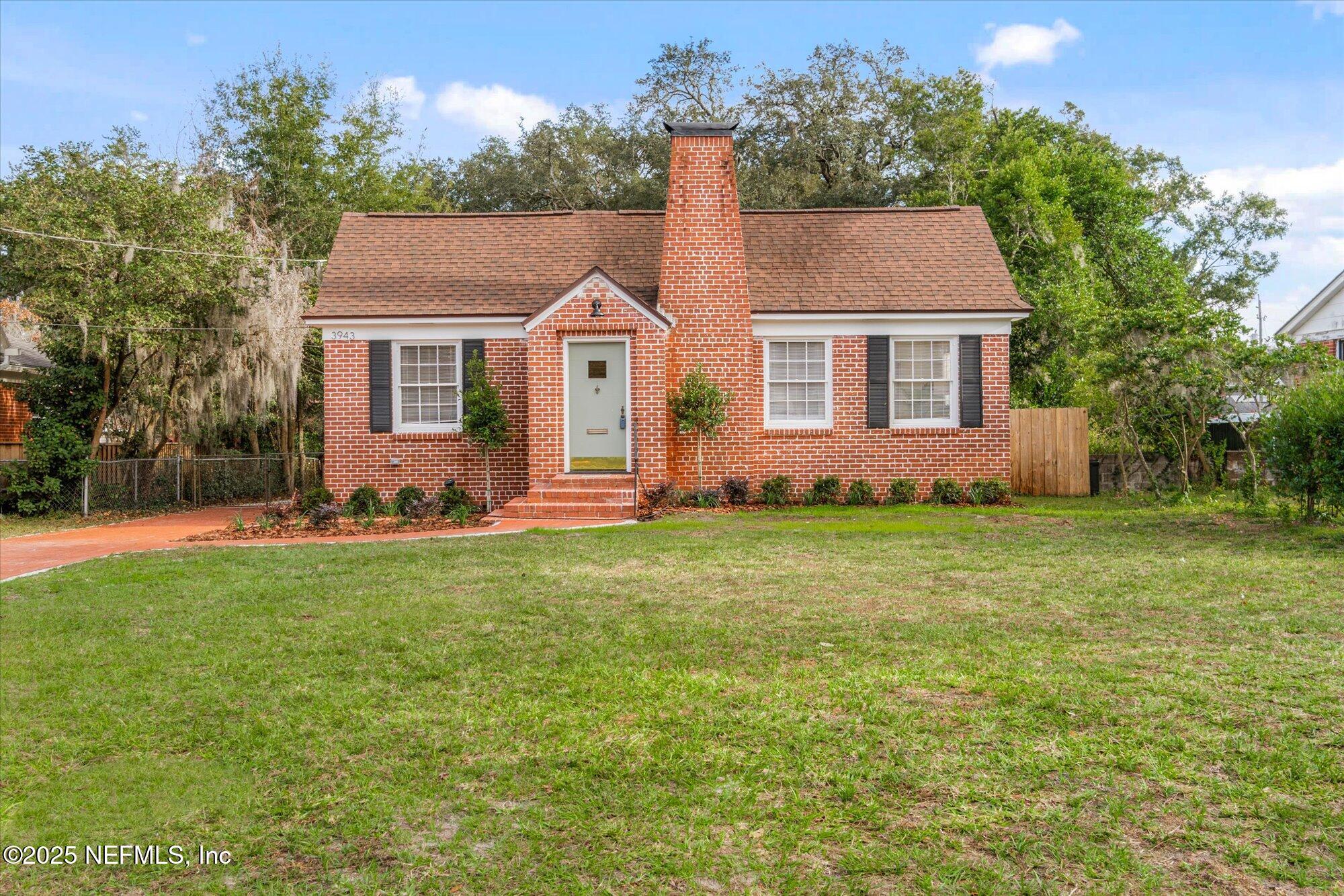 a front view of house with yard and green space