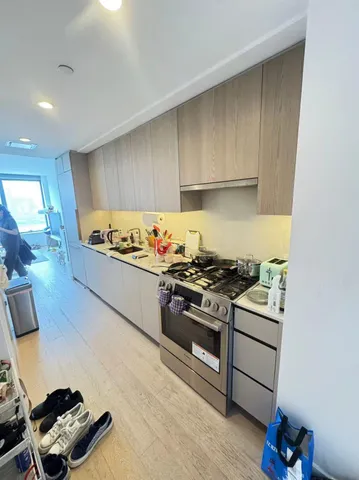 a kitchen with wooden cabinets and a stove top oven