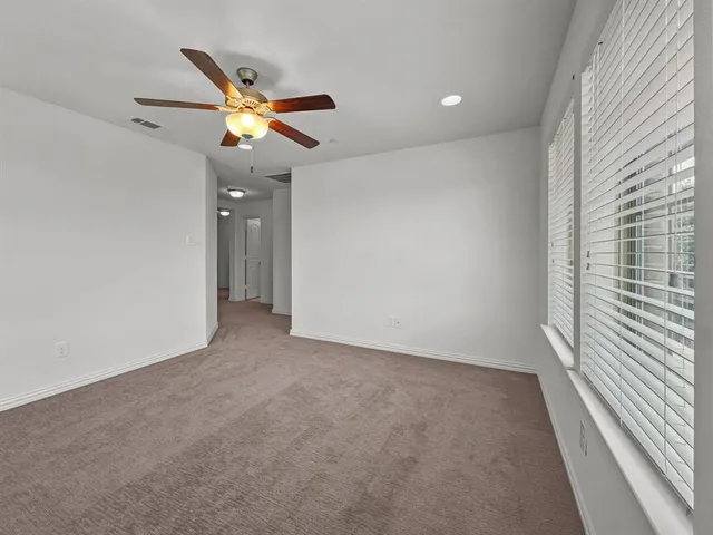 a view of a livingroom with a ceiling fan and window
