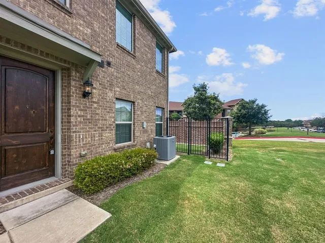 a view of backyard with barbeque grill and a wooden fence