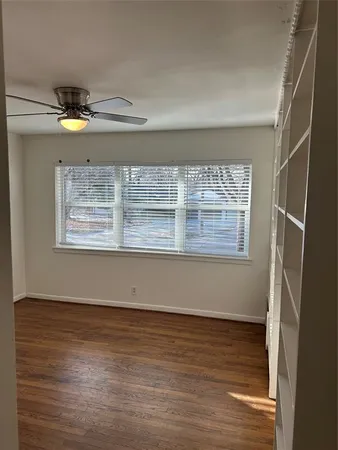 a view of room with window and wooden floor