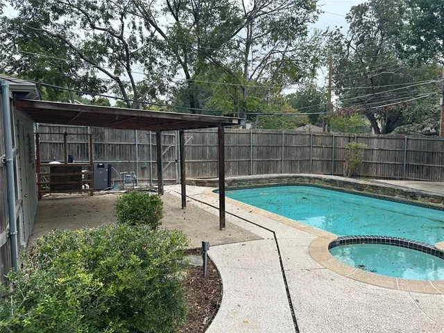 a view of a backyard with swimming pool