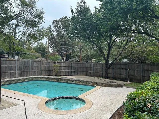 a view of a backyard with a small cabin and a chair